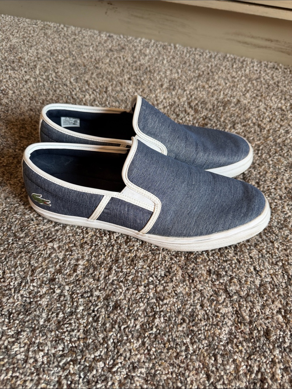 Lacoste Men's Tatalya Slip-On sneakers, featuring a blue denim-like upper 10.5